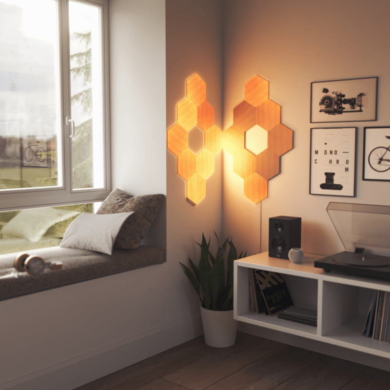 Nanoleaf Elements Thread enabled wood look hexagon smart modular light panels mounted to a wall beside a cozy nook. HomeKit, Google Assistant, Amazon Alexa, IFTTT.
