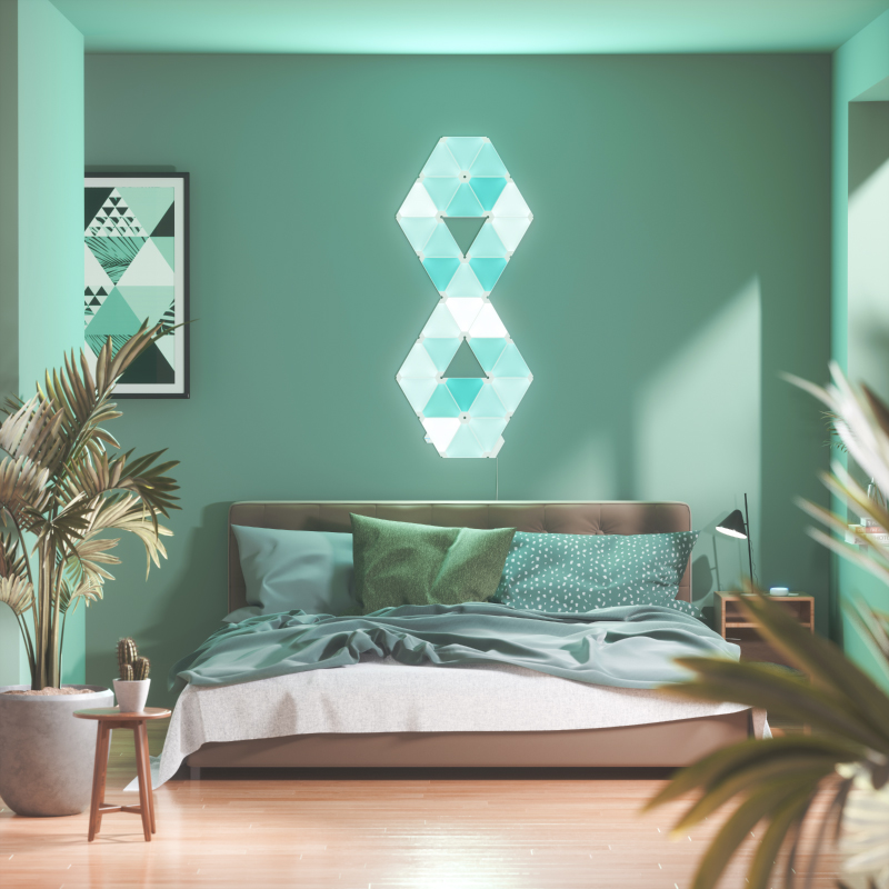 Nanoleaf Light Panels color-changing triangle smart modular light panels mounted to a wall in a bedroom. Similar to Philips Hue, Lifx. HomeKit, Google Assistant, Amazon Alexa, IFTTT.