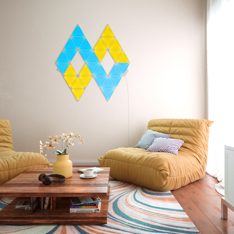 Nanoleaf Light Panels color-changing triangle smart modular light panels mounted to a wall in a living room. Similar to Philips Hue, Lifx. HomeKit, Google Assistant, Amazon Alexa, IFTTT.