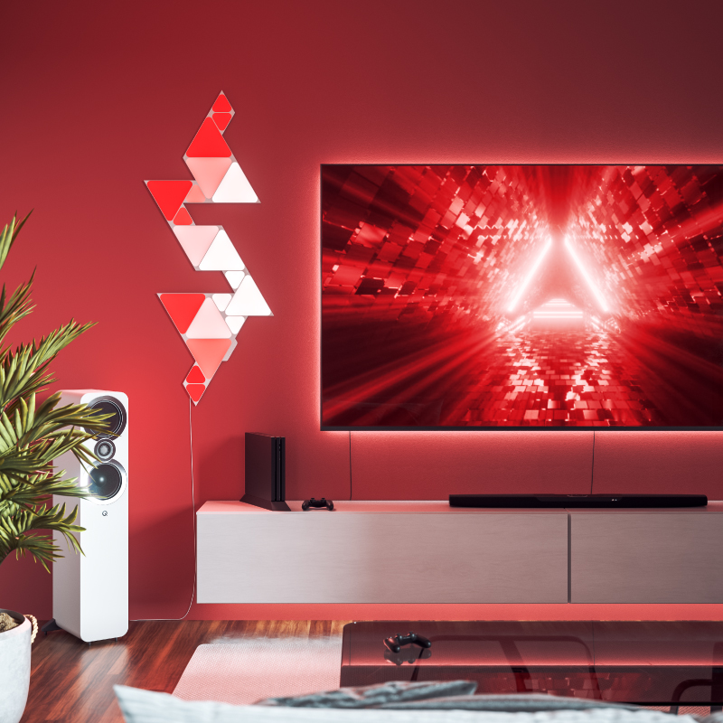 Nanoleaf Shapes Thread enabled color changing triangle smart modular light panels mounted to a wall in a living room. Similar to Philips Hue, Lifx. HomeKit, Google Assistant, Amazon Alexa, IFTTT.
